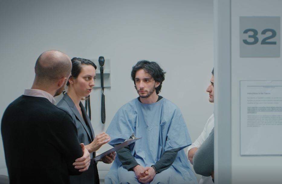 A student and an examiner interviewing a patient