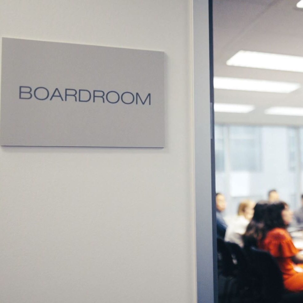 View into a boardroom with people gathered around a table